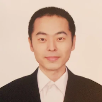 A person in formal attire in a headshot.